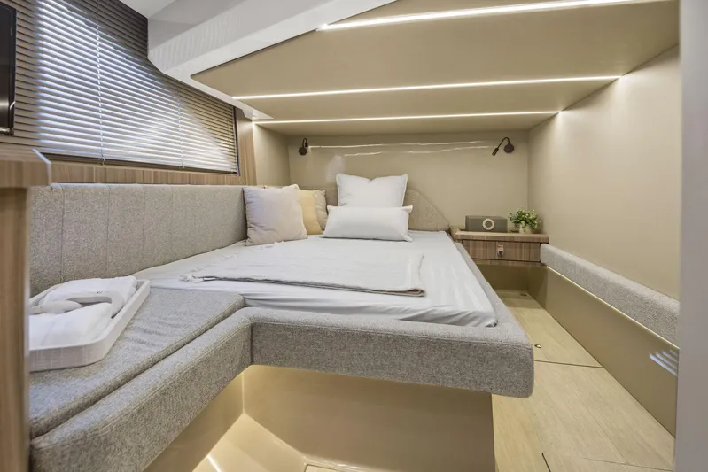  Yacht Photos Pics Luxurious cabin interior of 2026 Hanover 447 yacht with modern bedding and ambient lighting.
