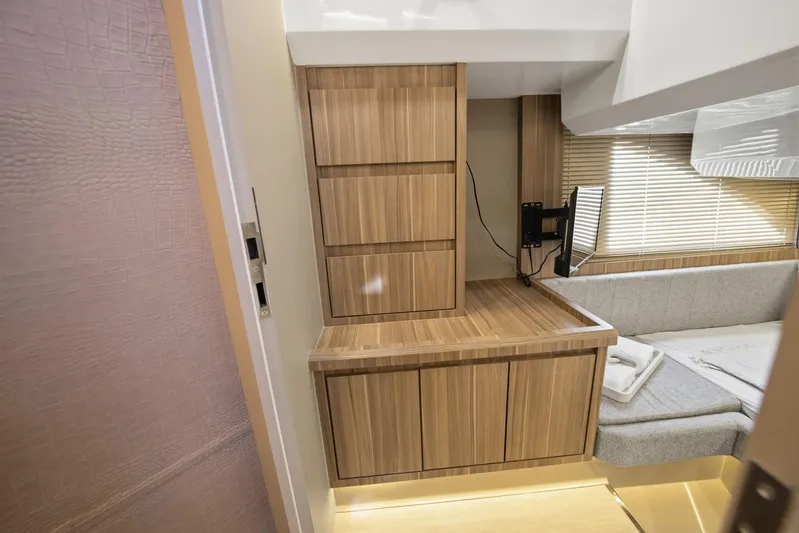  Yacht Photos Pics Modern interior of Hanover 447, 2026 model, featuring wood cabinetry and cozy seating area.