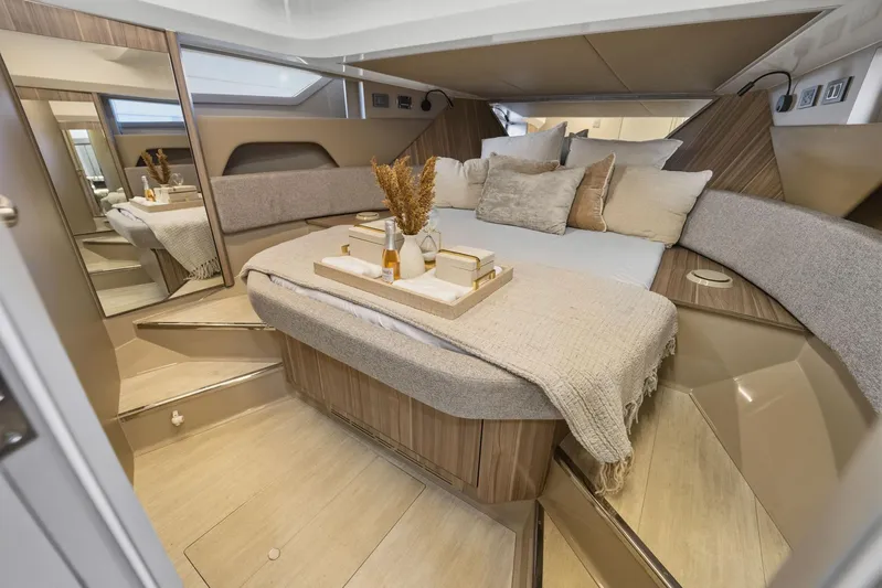  Yacht Photos Pics Luxurious cabin interior of 2026 Hanover 447 yacht with cozy bedding and elegant decor.