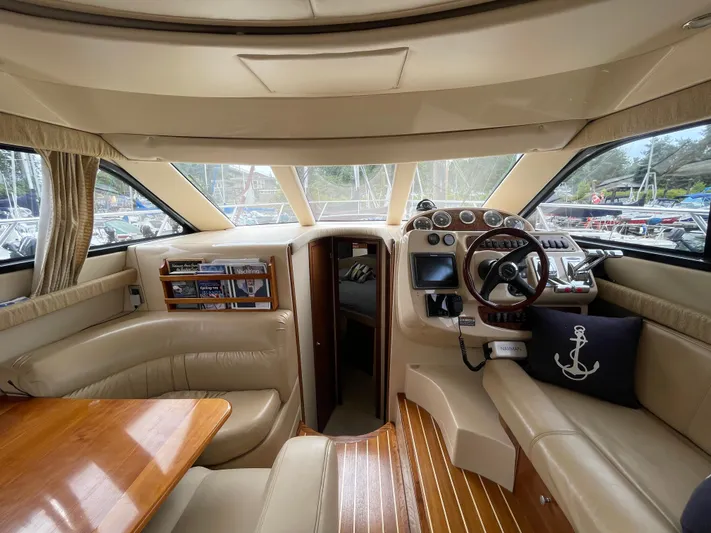 Queen Alexia Yacht Photos Pics Interior of a 2005 Meridian 341 Sedan yacht with luxurious seating and navigation controls.