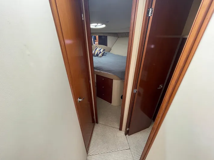Queen Alexia Yacht Photos Pics Interior of 2005 Meridian 341 Sedan yacht showing cozy bedroom with wooden doors.