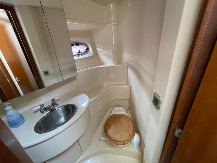 Queen Alexia Yacht Photos Pics 2005 Meridian 341 Sedan bathroom with sink, mirror, and toilet.
