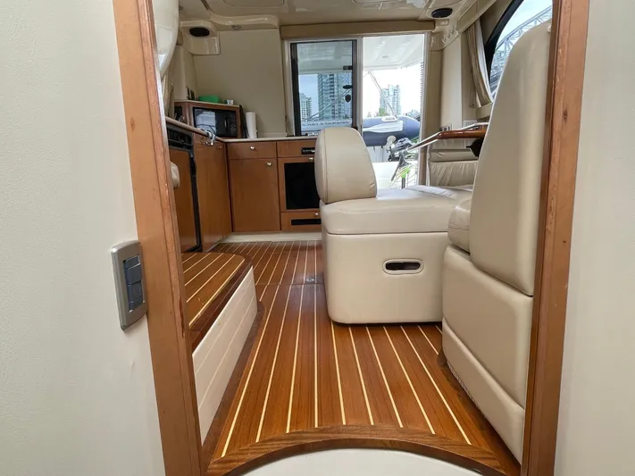 Queen Alexia Yacht Photos Pics Interior of 2005 Meridian 341 Sedan yacht with wooden flooring and beige seating.
