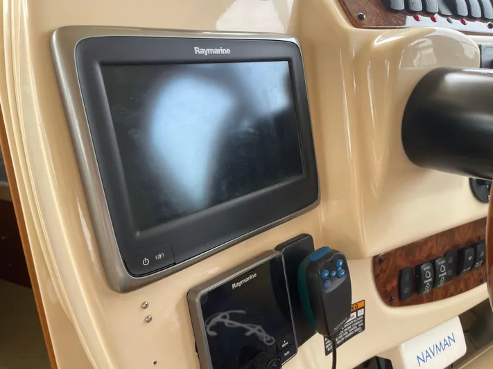 Queen Alexia Yacht Photos Pics 2005 Meridian 341 Sedan dashboard with Raymarine navigation system and controls.