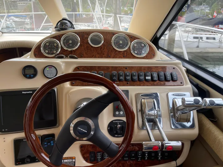 Queen Alexia Yacht Photos Pics 2005 Meridian 341 Sedan helm with gauges, controls, and steering wheel.