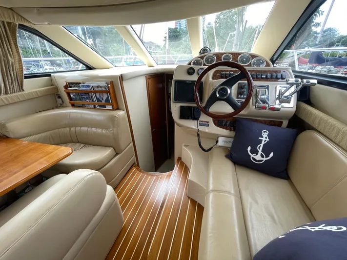 Queen Alexia Yacht Photos Pics 2005 Meridian 341 Sedan interior with leather seating, wooden accents, and nautical-themed decor.