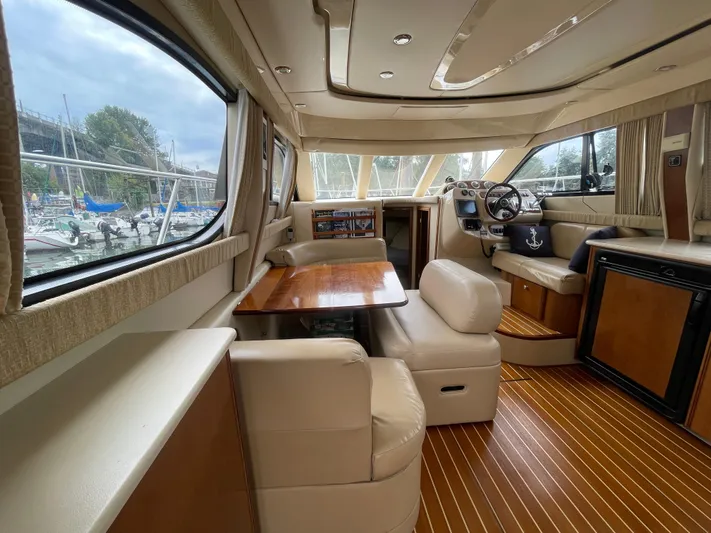 Queen Alexia Yacht Photos Pics Luxurious interior of a 2005 Meridian 341 Sedan yacht with elegant seating and wood finishes.