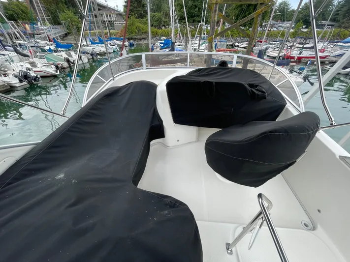 Queen Alexia Yacht Photos Pics 2005 Meridian 341 Sedan boat with covered seating at a marina.