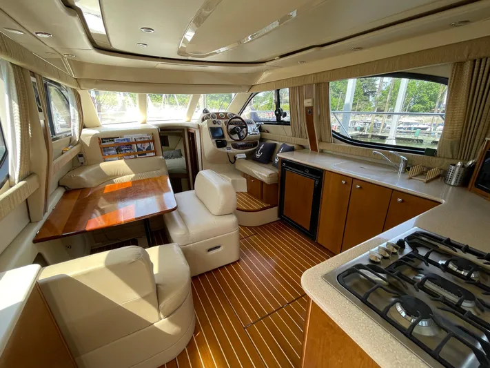 Queen Alexia Yacht Photos Pics Luxurious interior of a 2005 Meridian 341 Sedan yacht with kitchen and seating area.