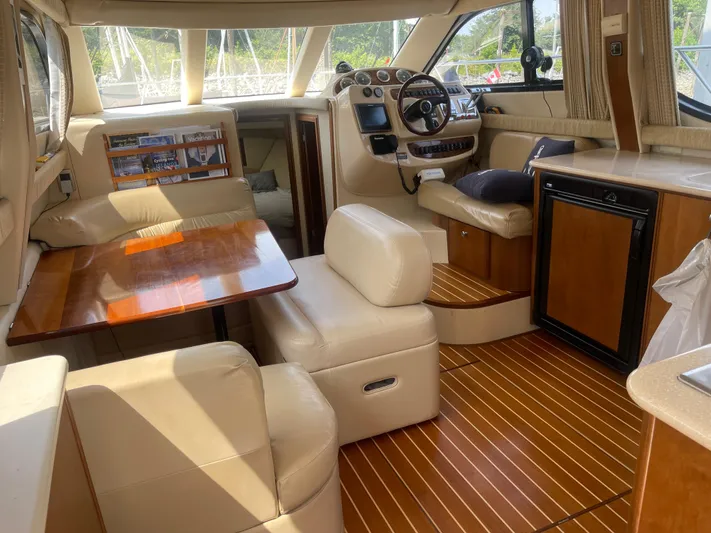 Queen Alexia Yacht Photos Pics Luxurious interior of a 2005 Meridian 341 Sedan yacht with leather seating and wooden accents.