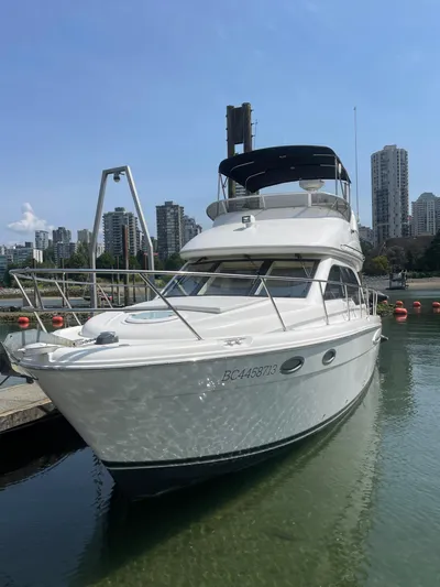 Queen Alexia Yacht Photos Pics 2005 Meridian 341 Sedan yacht docked in a marina with city skyline background.