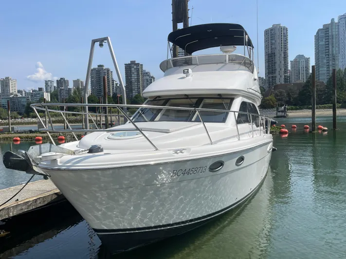 Queen Alexia Yacht Photos Pics 2005 Meridian 341 Sedan yacht docked in urban marina with city skyline.
