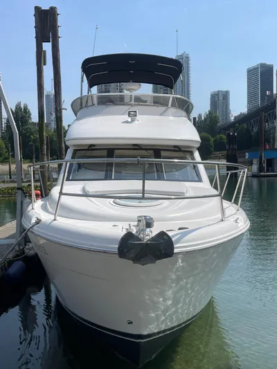 Queen Alexia Yacht Photos Pics 2005 Meridian 341 Sedan yacht docked in a marina with city skyline background.