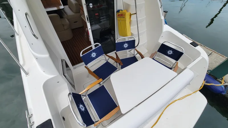 Queen Alexia Yacht Photos Pics 2005 Meridian 341 Sedan yacht with outdoor seating and table setup.