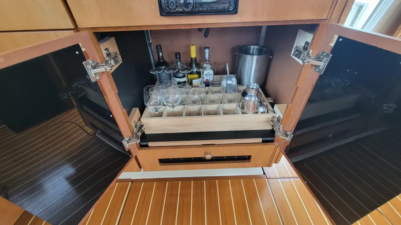 Queen Alexia Yacht Photos Pics Bar cabinet on 2005 Meridian 341 Sedan yacht with glasses and bottles.