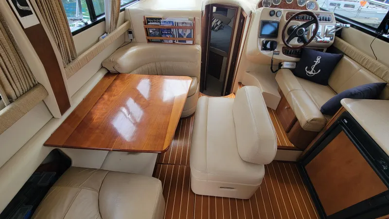 Queen Alexia Yacht Photos Pics Luxurious interior of a 2005 Meridian 341 Sedan yacht with leather seating and wooden accents.