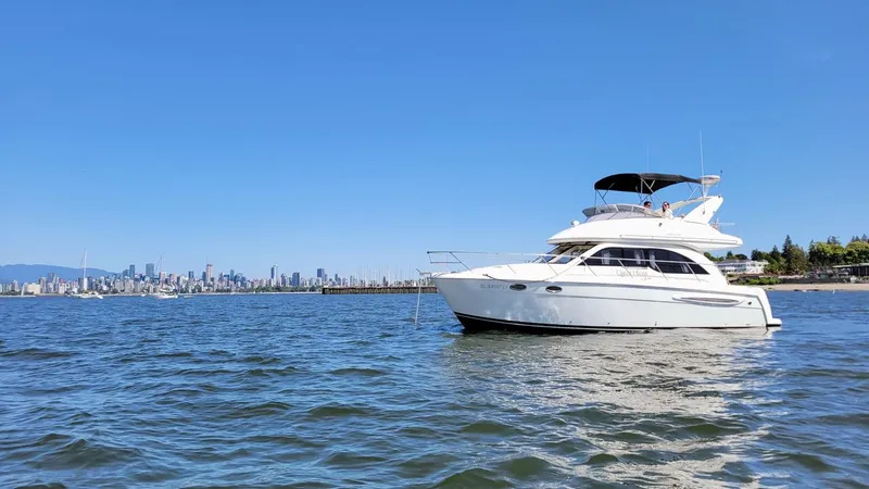 Queen Alexia Yacht Photos Pics 2005 Meridian 341 Sedan yacht on water with city skyline in background.