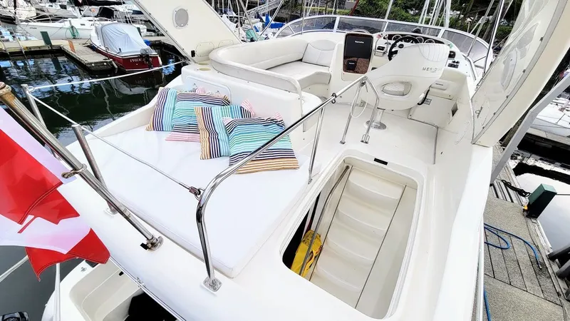 Queen Alexia Yacht Photos Pics 2005 Meridian 341 Sedan yacht with striped cushions, docked at marina.