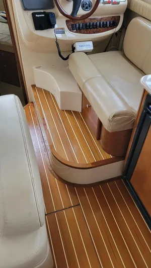 Queen Alexia Yacht Photos Pics Interior of 2005 Meridian 341 Sedan with wooden flooring and beige seating.