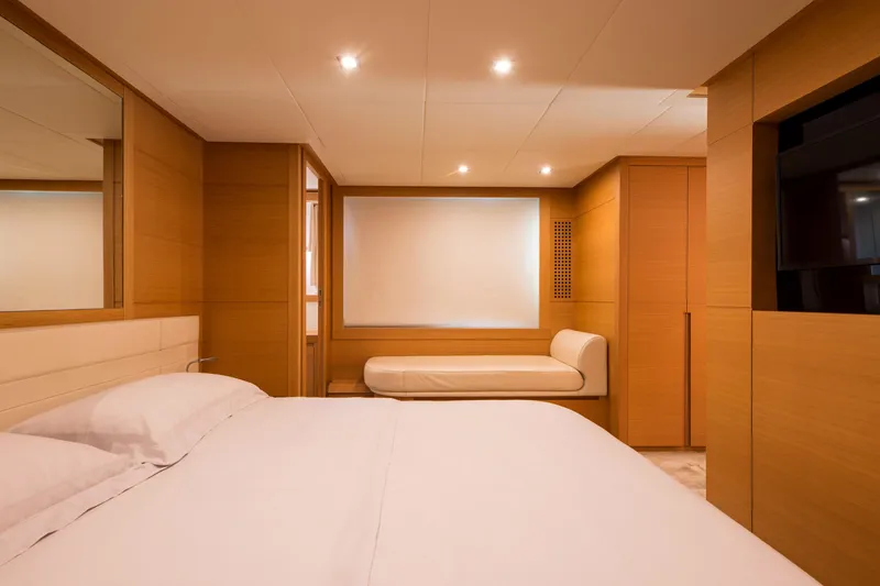 Pax Yacht Photos Pics Luxurious bedroom interior of 2008 Pershing 64 yacht with modern wood paneling.