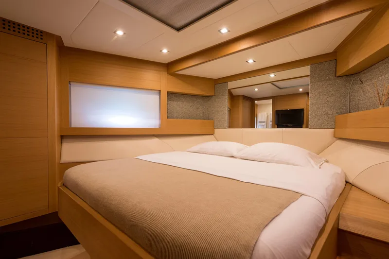 Pax Yacht Photos Pics Luxurious bedroom interior of 2008 Pershing 64 yacht with modern design and cozy ambiance.
