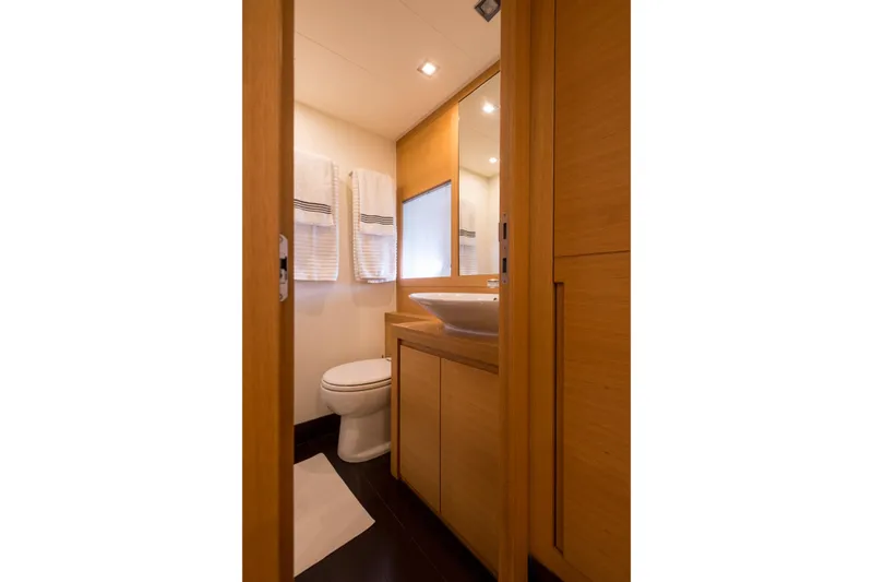 Pax Yacht Photos Pics Luxurious bathroom interior of 2008 Pershing 64 yacht with modern fixtures and wooden cabinetry.