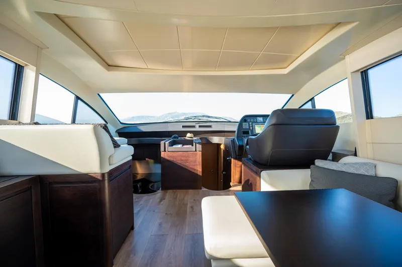 Pax Yacht Photos Pics Luxurious interior of 2008 Pershing 64 yacht with modern seating and panoramic windows.