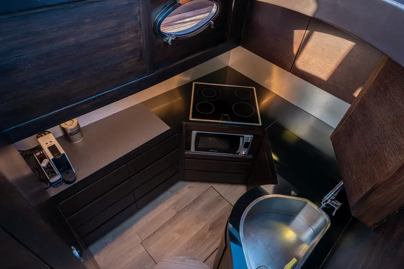 Pax Yacht Photos Pics Luxurious 2008 Pershing 64 yacht kitchen with modern appliances and sleek design.