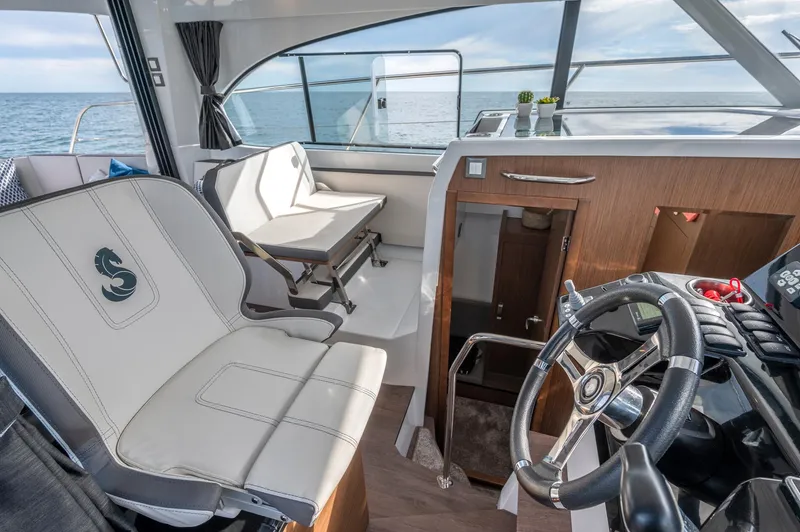  Yacht Photos Pics Interior of 2026 Beneteau Antares 11 Fly, featuring helm and seating area.