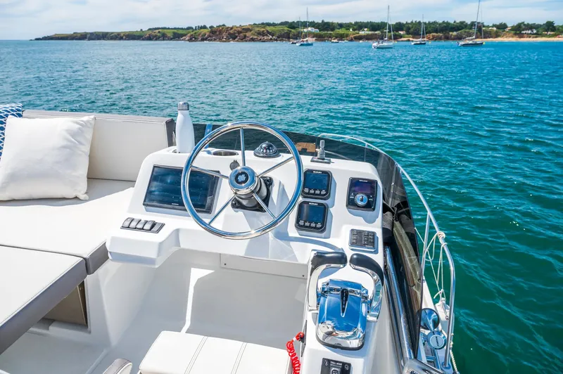  Yacht Photos Pics 2026 Beneteau Antares 11 Fly yacht helm, featuring modern controls and scenic ocean view.