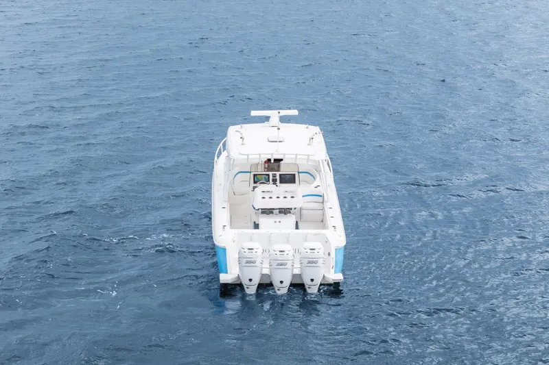  Yacht Photos Pics 2018 Intrepid 407 Cuddy boat on open water, rear view with four engines.