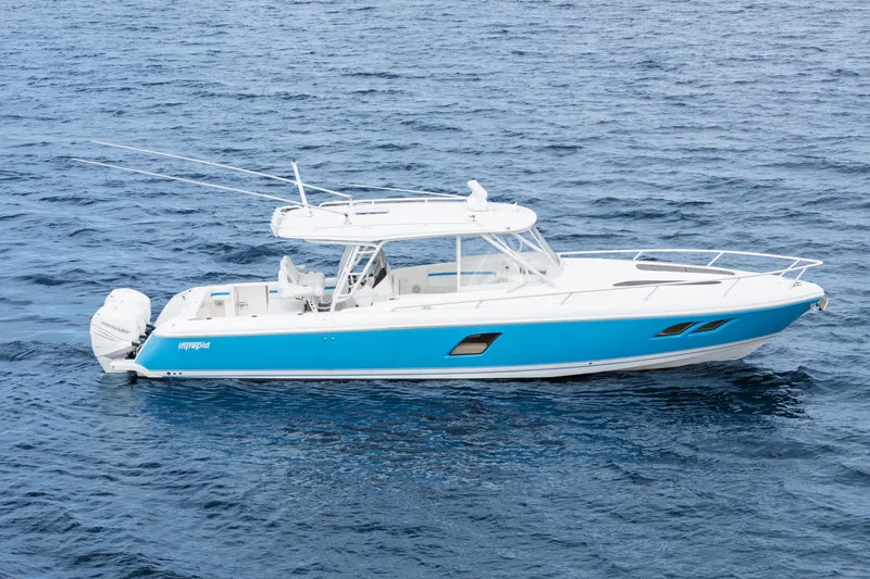  Yacht Photos Pics 2018 Intrepid 407 Cuddy boat on open water, featuring a sleek blue and white design.