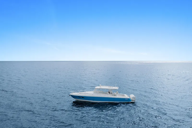  Yacht Photos Pics 2018 Intrepid 407 Cuddy boat cruising on open blue sea under clear sky.
