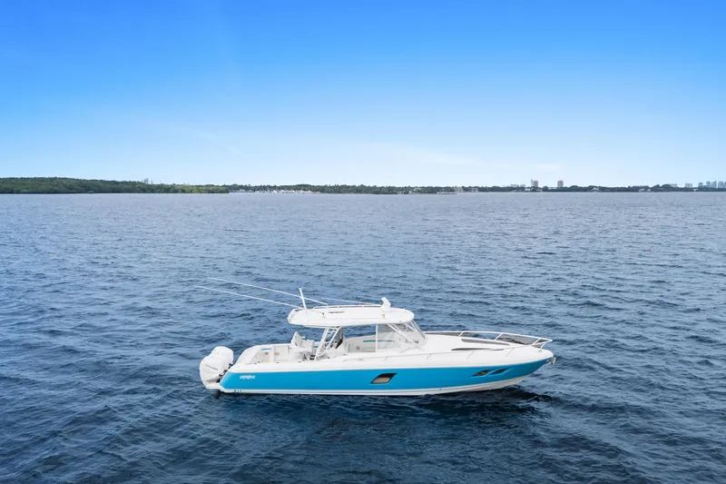  Yacht Photos Pics 2018 Intrepid 407 Cuddy boat on open water under clear blue sky.