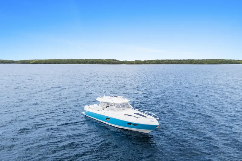  Yacht Photos Pics 2018 Intrepid 407 Cuddy boat on open water under clear blue sky.