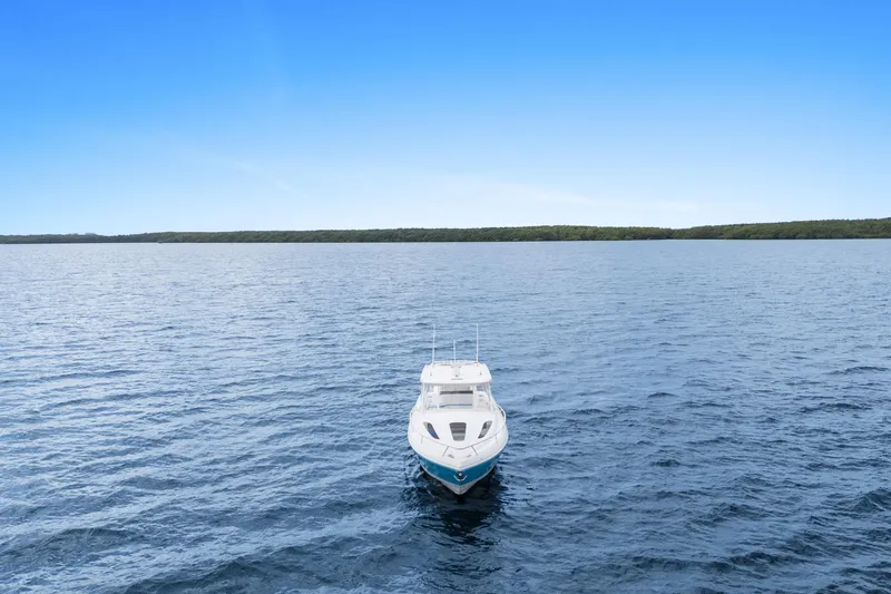  Yacht Photos Pics 2018 Intrepid 407 Cuddy boat on open water under clear blue sky.
