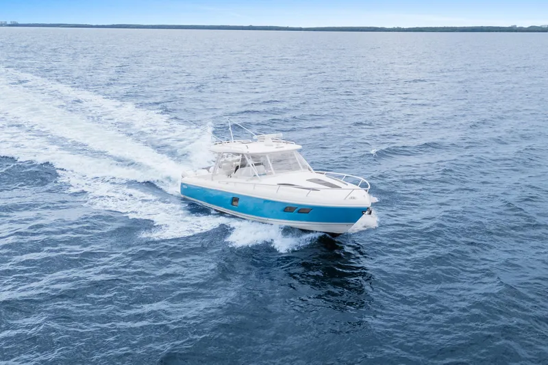  Yacht Photos Pics 2018 Intrepid 407 Cuddy cruising on open water, showcasing sleek design and performance.