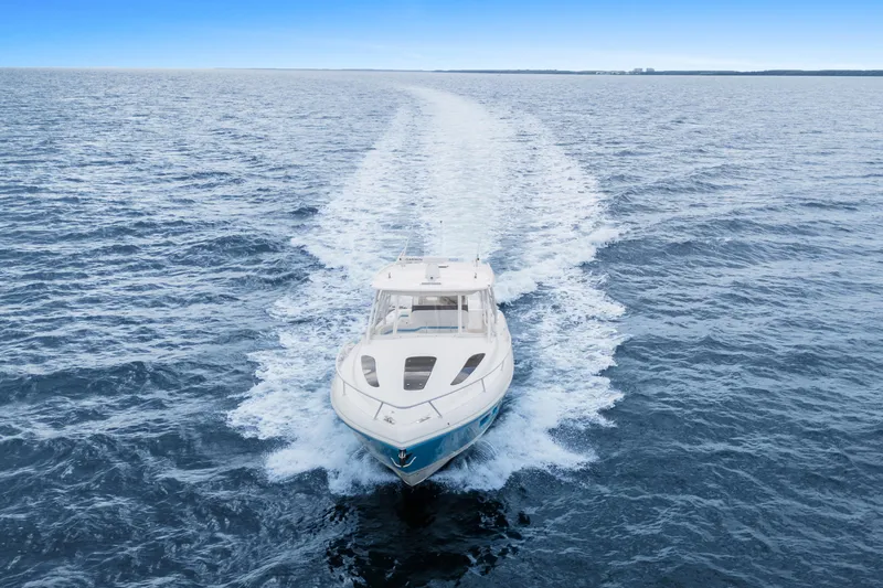  Yacht Photos Pics 2018 Intrepid 407 Cuddy cruising on open ocean, leaving a wake trail.