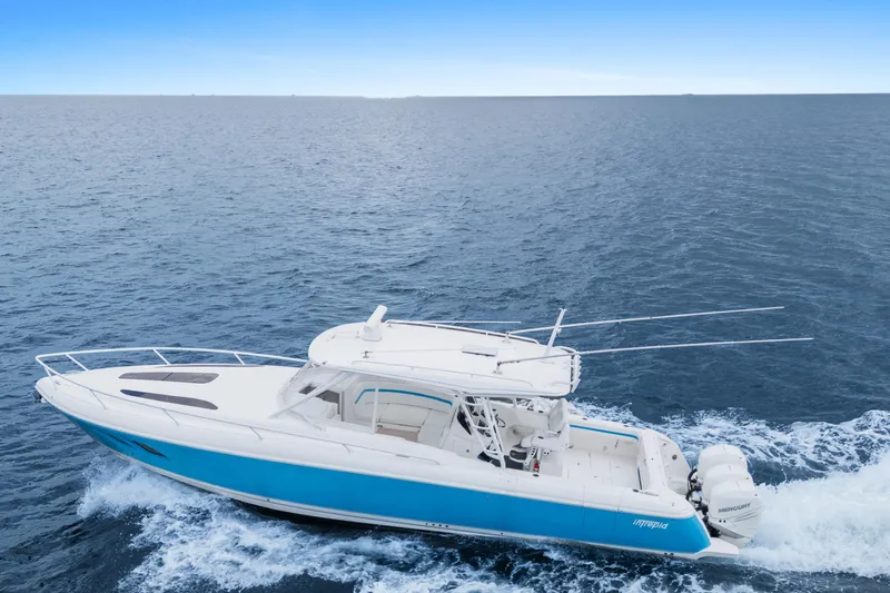  Yacht Photos Pics 2018 Intrepid 407 Cuddy cruising on open ocean, showcasing sleek design and powerful engines.