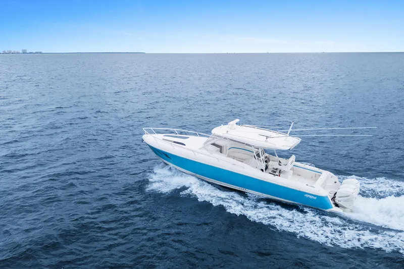  Yacht Photos Pics 2018 Intrepid 407 Cuddy cruising on open blue ocean waters.