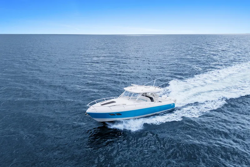  Yacht Photos Pics 2018 Intrepid 407 Cuddy cruising on open ocean under clear blue sky.