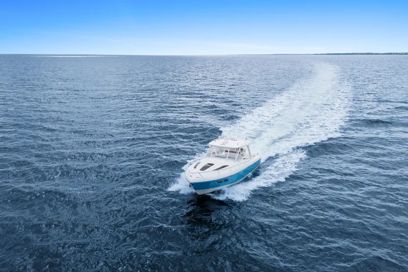  Yacht Photos Pics 2018 Intrepid 407 Cuddy cruising on open ocean under clear blue sky.