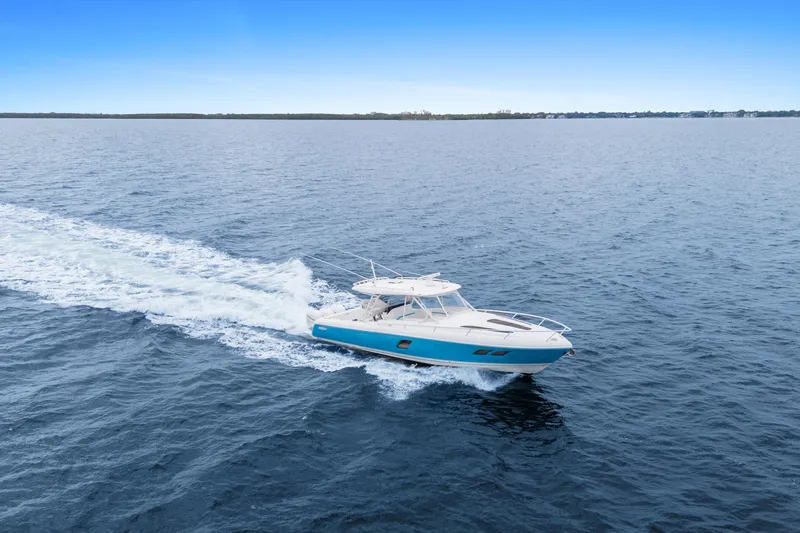  Yacht Photos Pics 2018 Intrepid 407 Cuddy cruising on open water under clear blue sky.