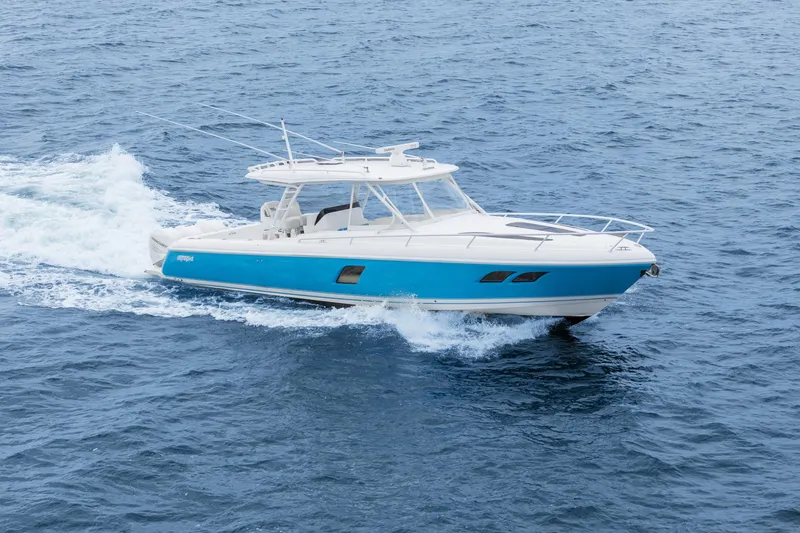  Yacht Photos Pics 2018 Intrepid 407 Cuddy cruising on open water, showcasing sleek design and vibrant blue hull.