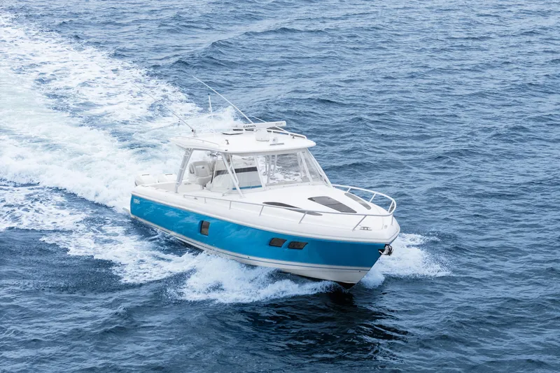  Yacht Photos Pics 2018 Intrepid 407 Cuddy cruising on open ocean waters.