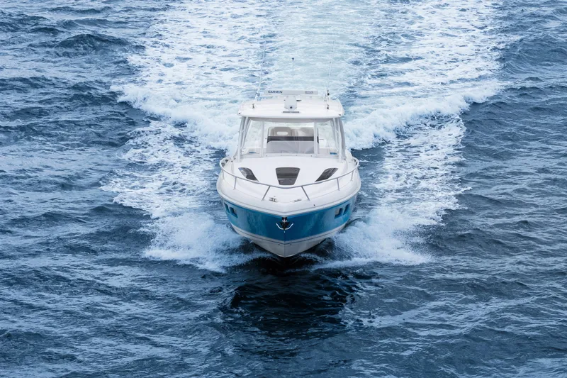  Yacht Photos Pics 2018 Intrepid 407 Cuddy cruising on open water, creating a dynamic wake.