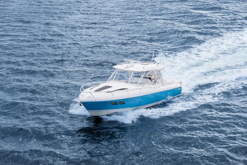  Yacht Photos Pics 2018 Intrepid 407 Cuddy cruising on open ocean waters.