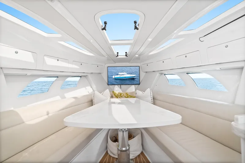  Yacht Photos Pics Luxurious interior of 2018 Intrepid 407 Cuddy boat with elegant seating and ocean view.