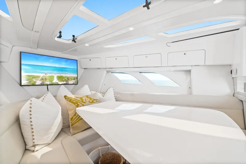  Yacht Photos Pics Luxurious interior of 2018 Intrepid 407 Cuddy with plush seating and large TV screen.