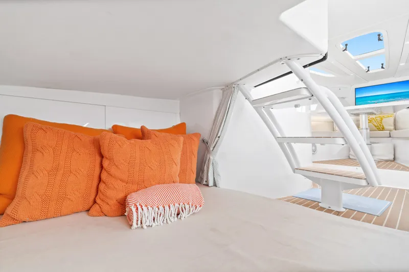  Yacht Photos Pics 2018 Intrepid 407 Cuddy interior with orange pillows and modern design.